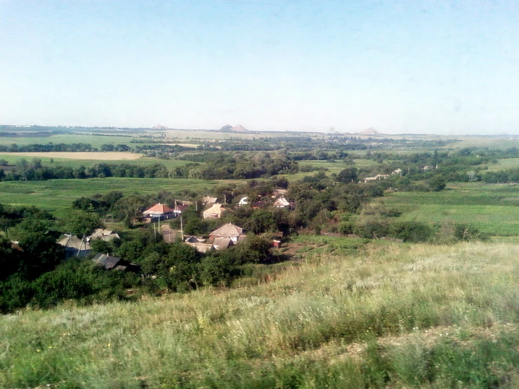 an overview view of a green landscape with a few houses