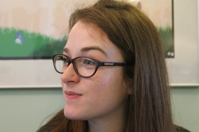 a woman wearing glasses with long hair and a necklace