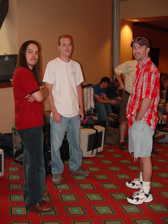 three people holding wii remotes in a room