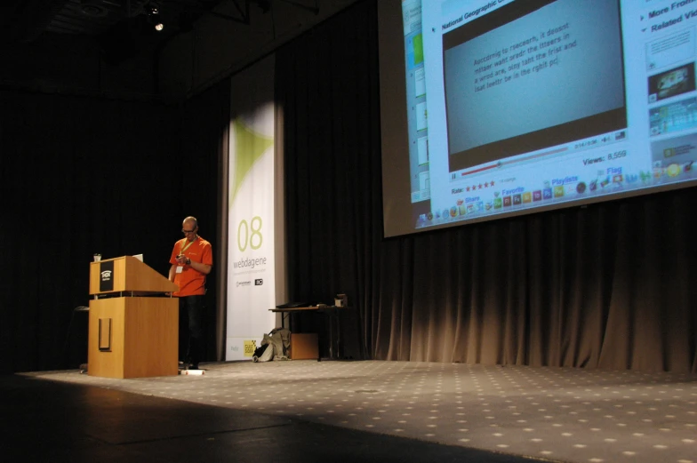 an man stands at a podium giving a presentation