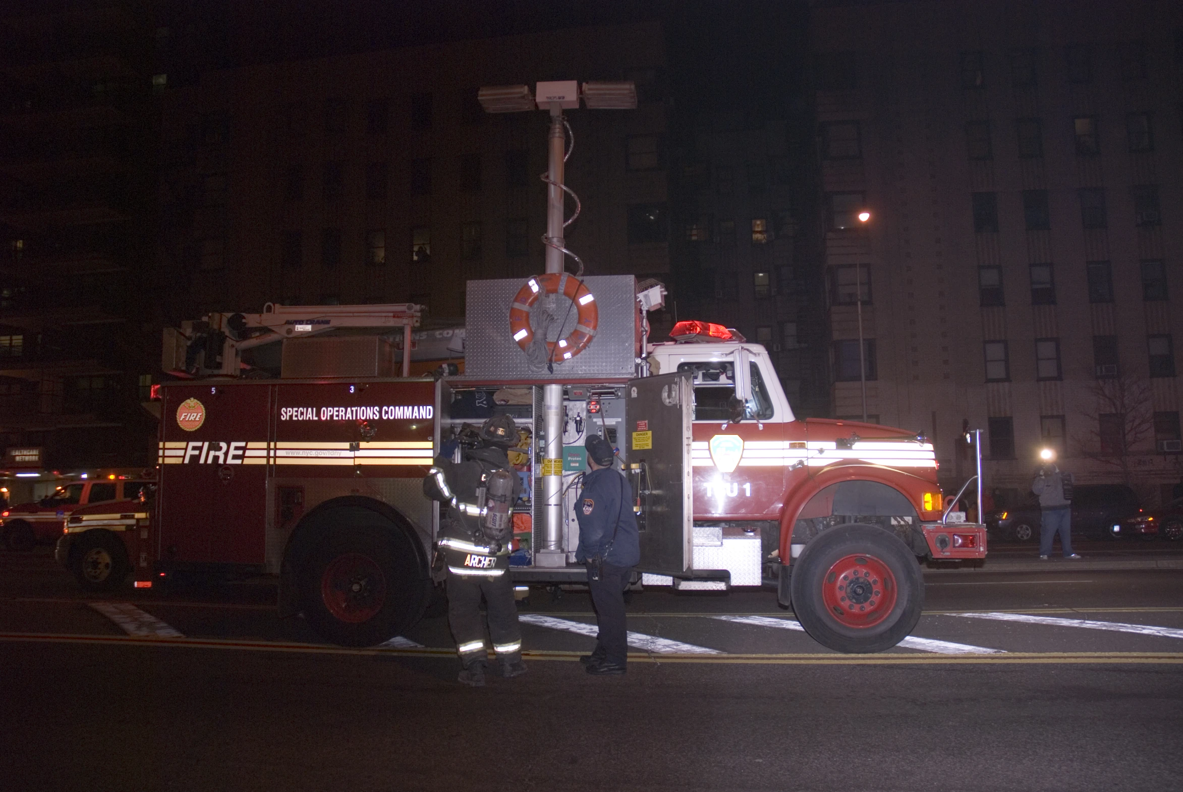 a man and a fire truck in a large city street