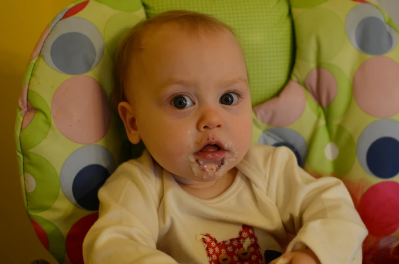 a baby with some food in his mouth