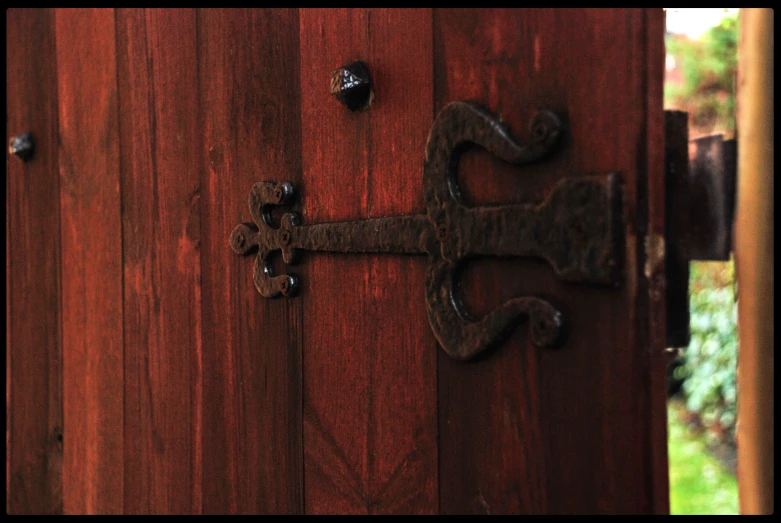 a metal skeleton door handle on a wooden door