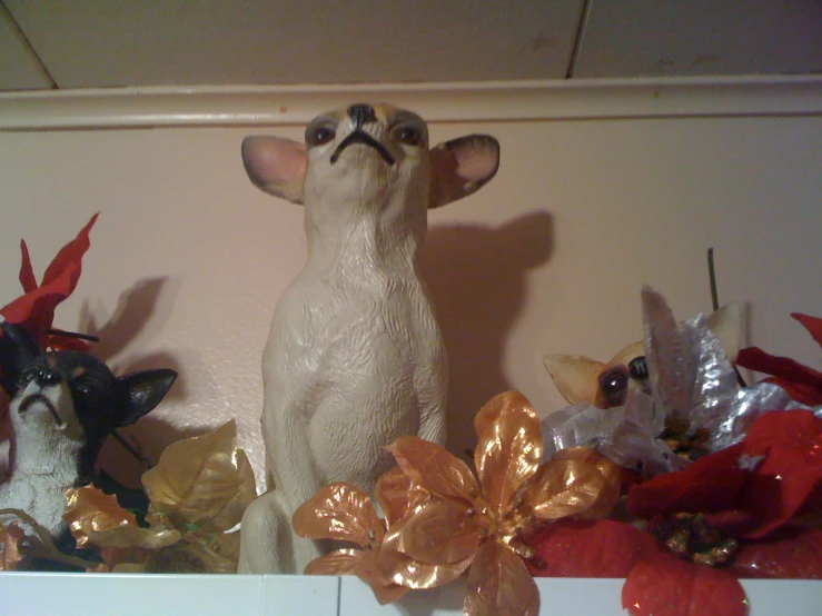 two different figurines of animals on top of white shelves
