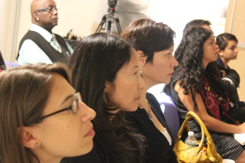 a group of women sitting next to each other