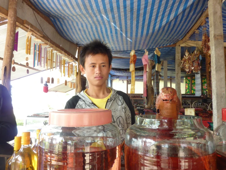 a person standing near jars full of liquid