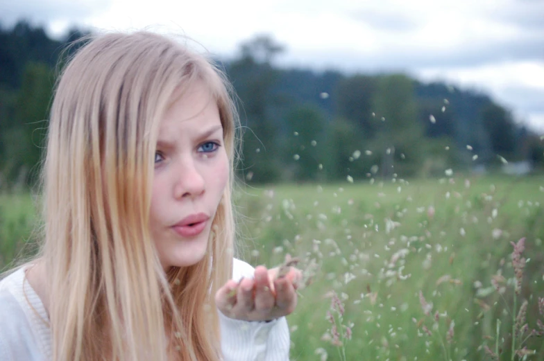 a girl looking away in the middle of a field