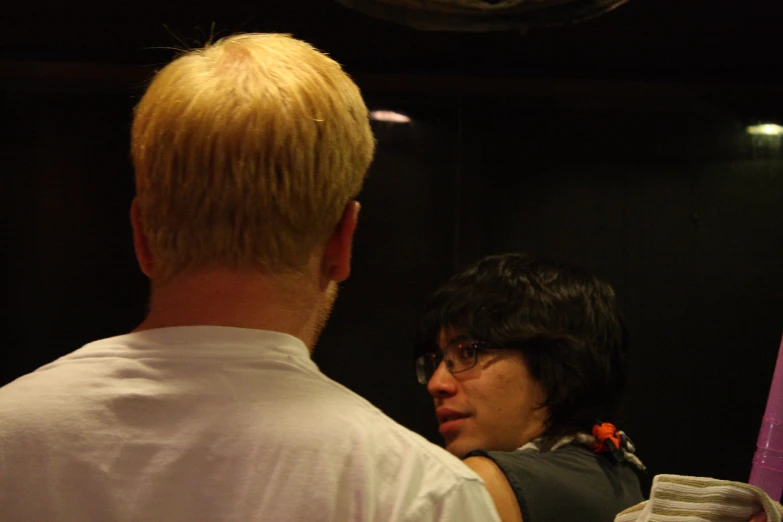 a woman in a white shirt and red scarf looking into the mirror