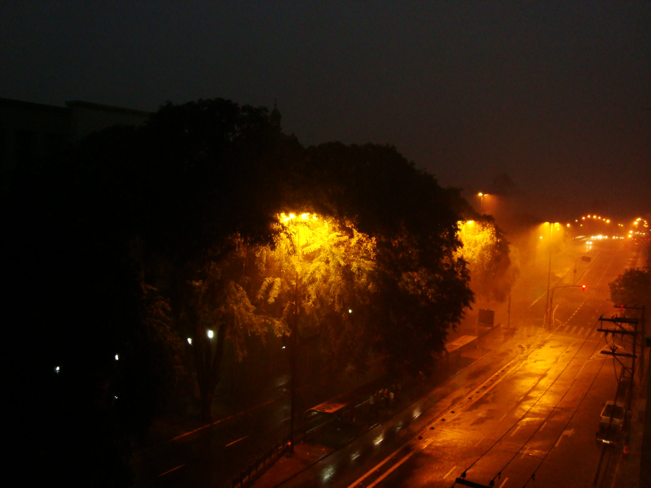 an empty road with traffic and lights at night