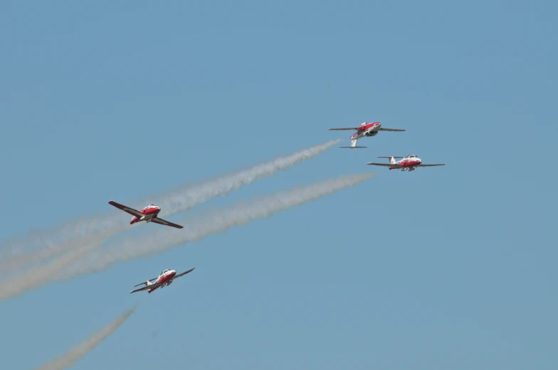 several planes flying in formation at an air show