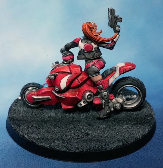 a red motorcycle with a woman holding a gun