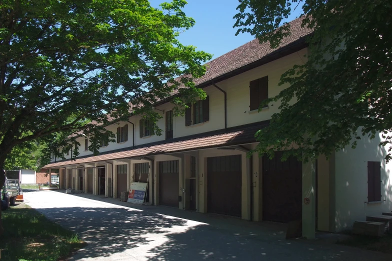 several different sizes and shapes of garages lined along the side of a house