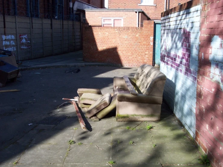 some couches and chairs are parked against the wall