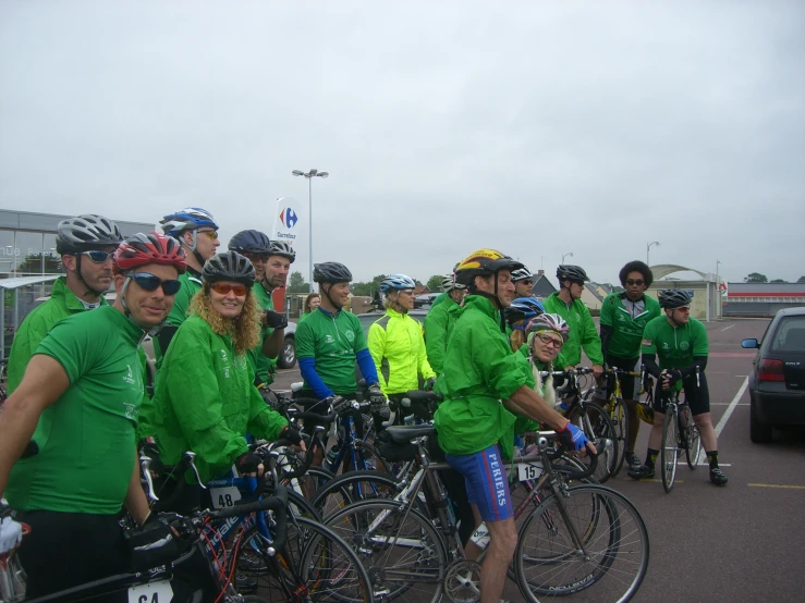 a group of bikers on bicycles stopped in a parking lot