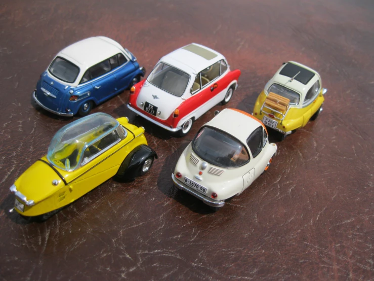 several toys cars arranged on brown leather surface
