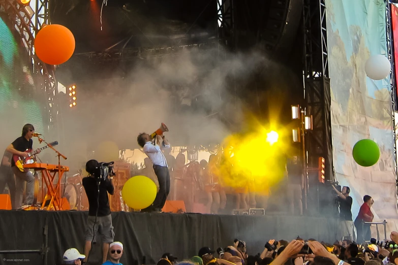 two people singing at a concert on stage