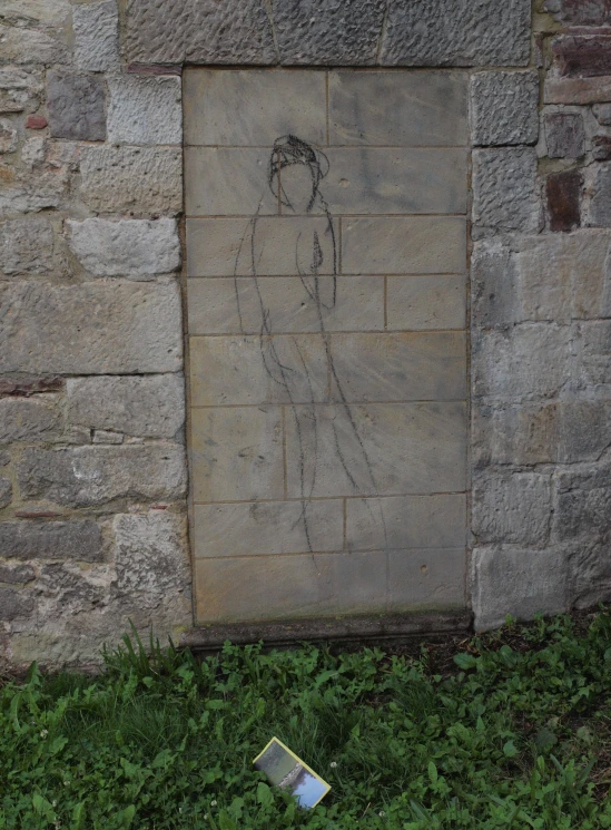 a brick wall with a drawing of a woman