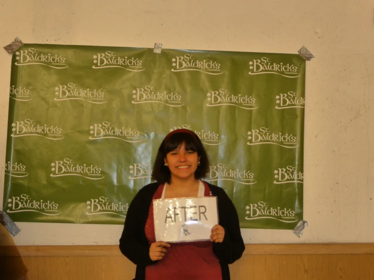 a woman in an apron standing next to a banner