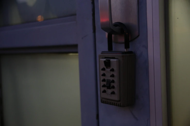 an electronic device on a door lock at night