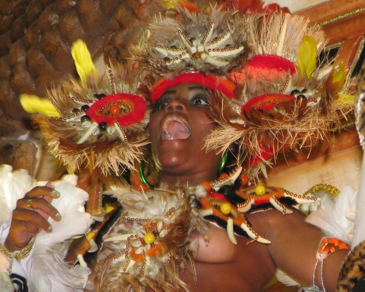 a person in costume with feathers making faces