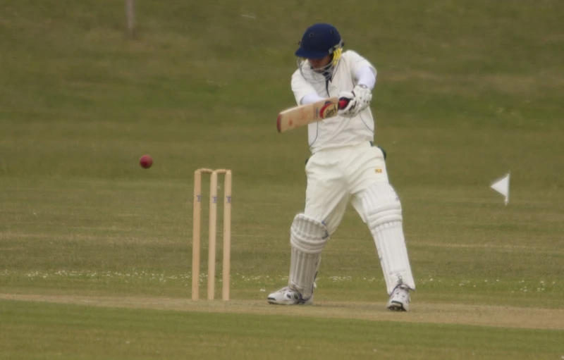 the person is batting during a game of cricket