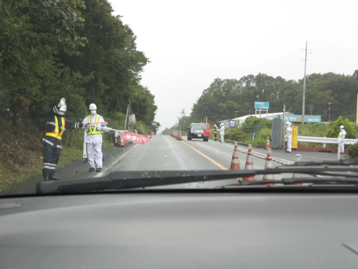 workers are working on the side of the road