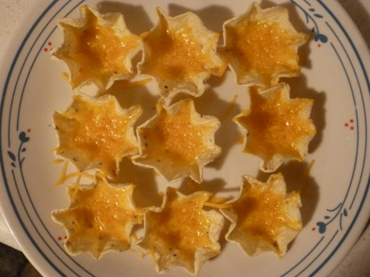 several baked stars on a white plate with blue trim