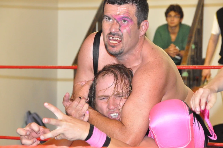 two wrestlers emcing each other in an ring
