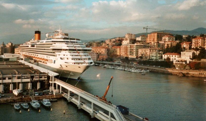 cruise ship in the distance passing under a bridge