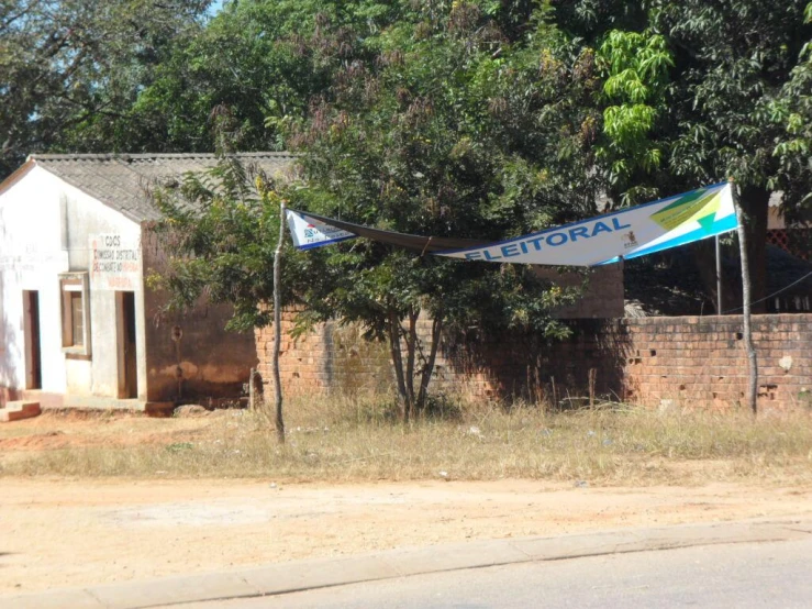 a house on a corner in the background, with a sail boat laying across the street