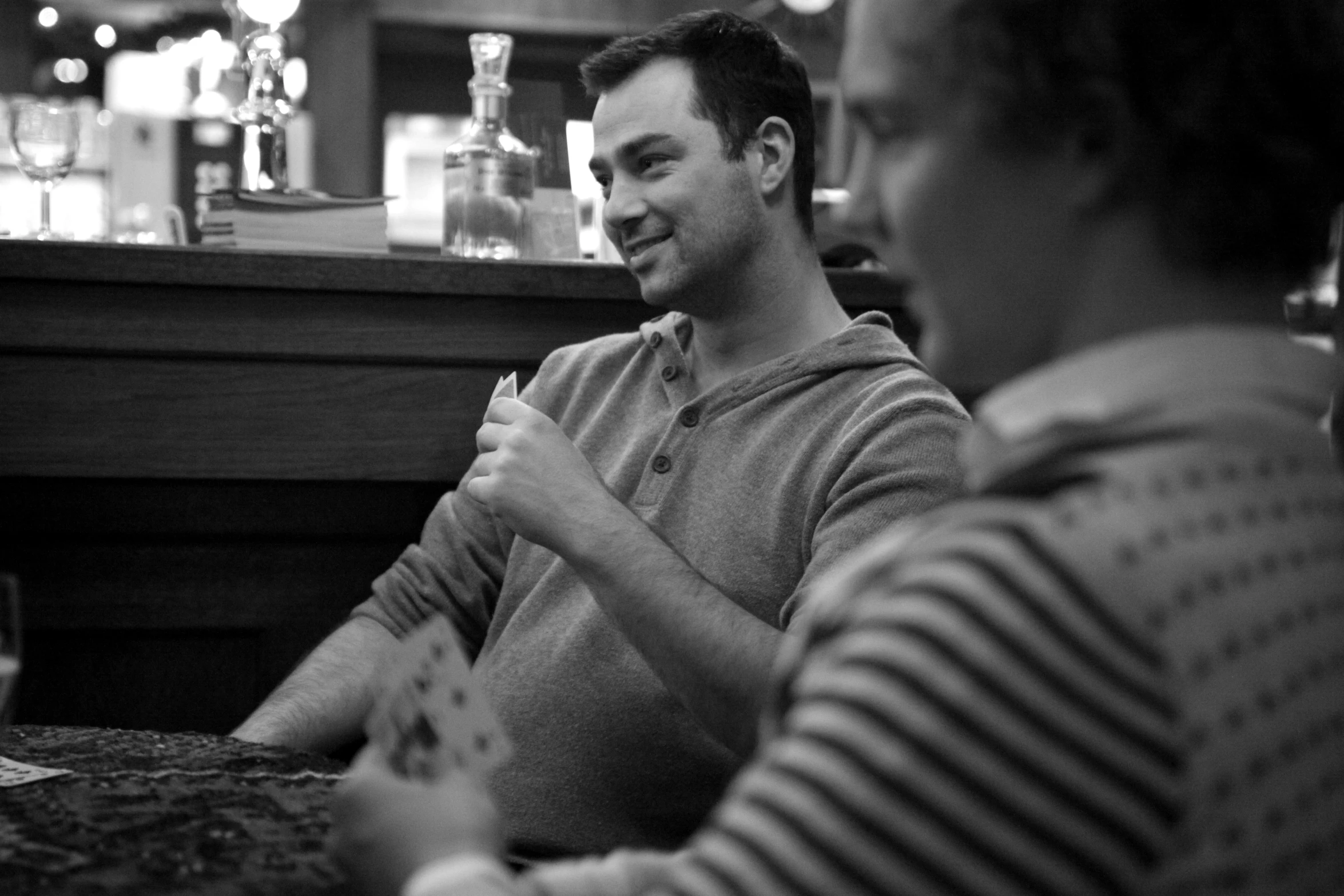 two men sitting at a table with some drinks