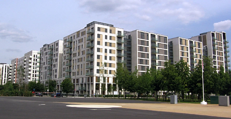 a large white apartment building on the corner of the street