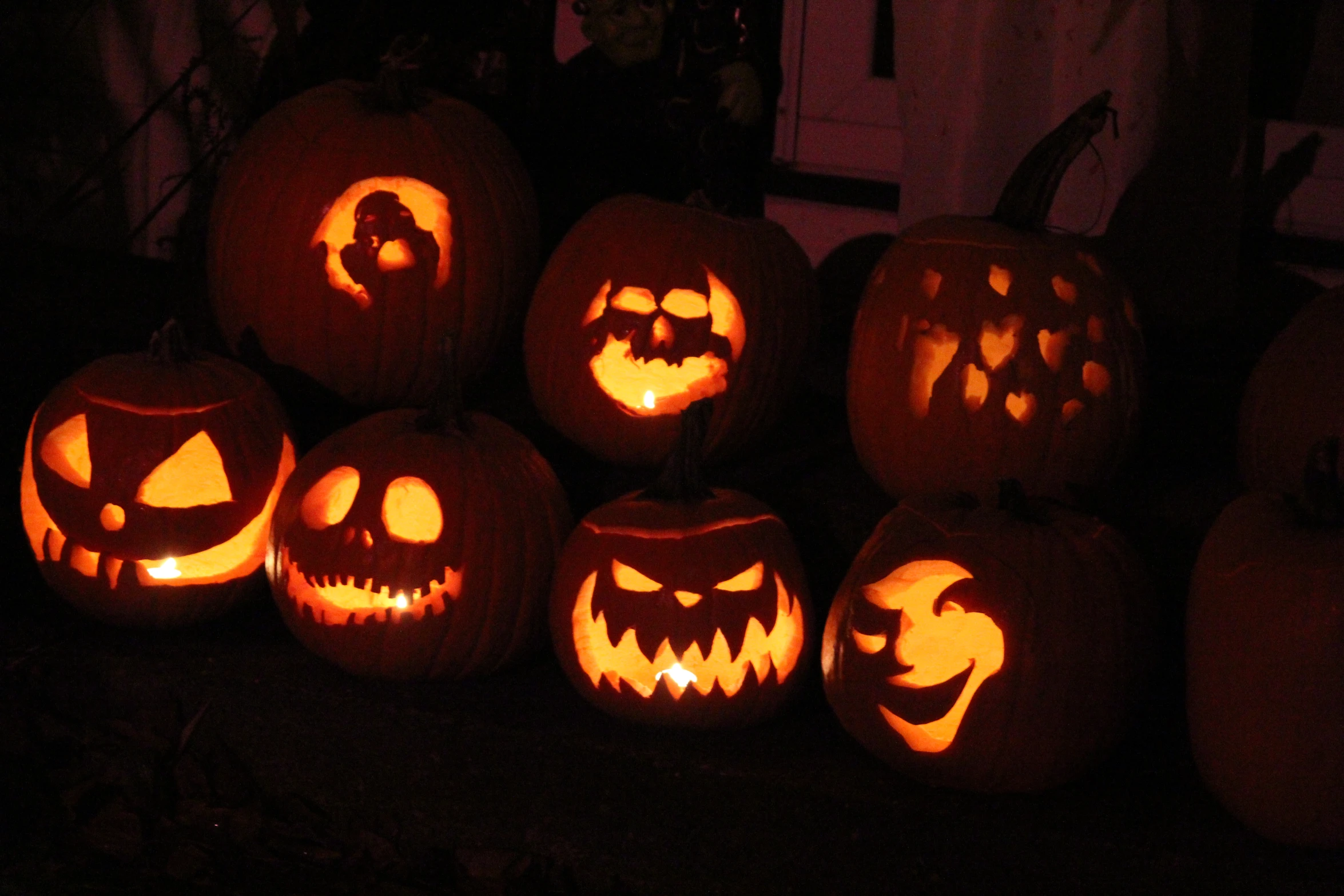 a row of pumpkins carved into the shape of jack o lantern faces