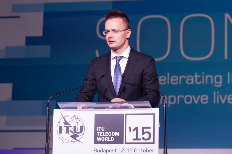 a man in a suit is at a podium