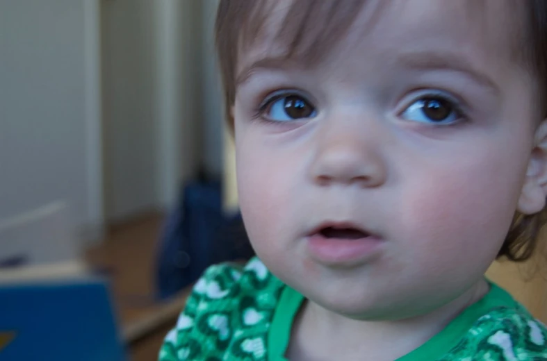 a close up of a small child holding a phone