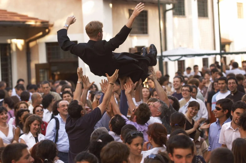 large crowd of people reaching out to get dressed up