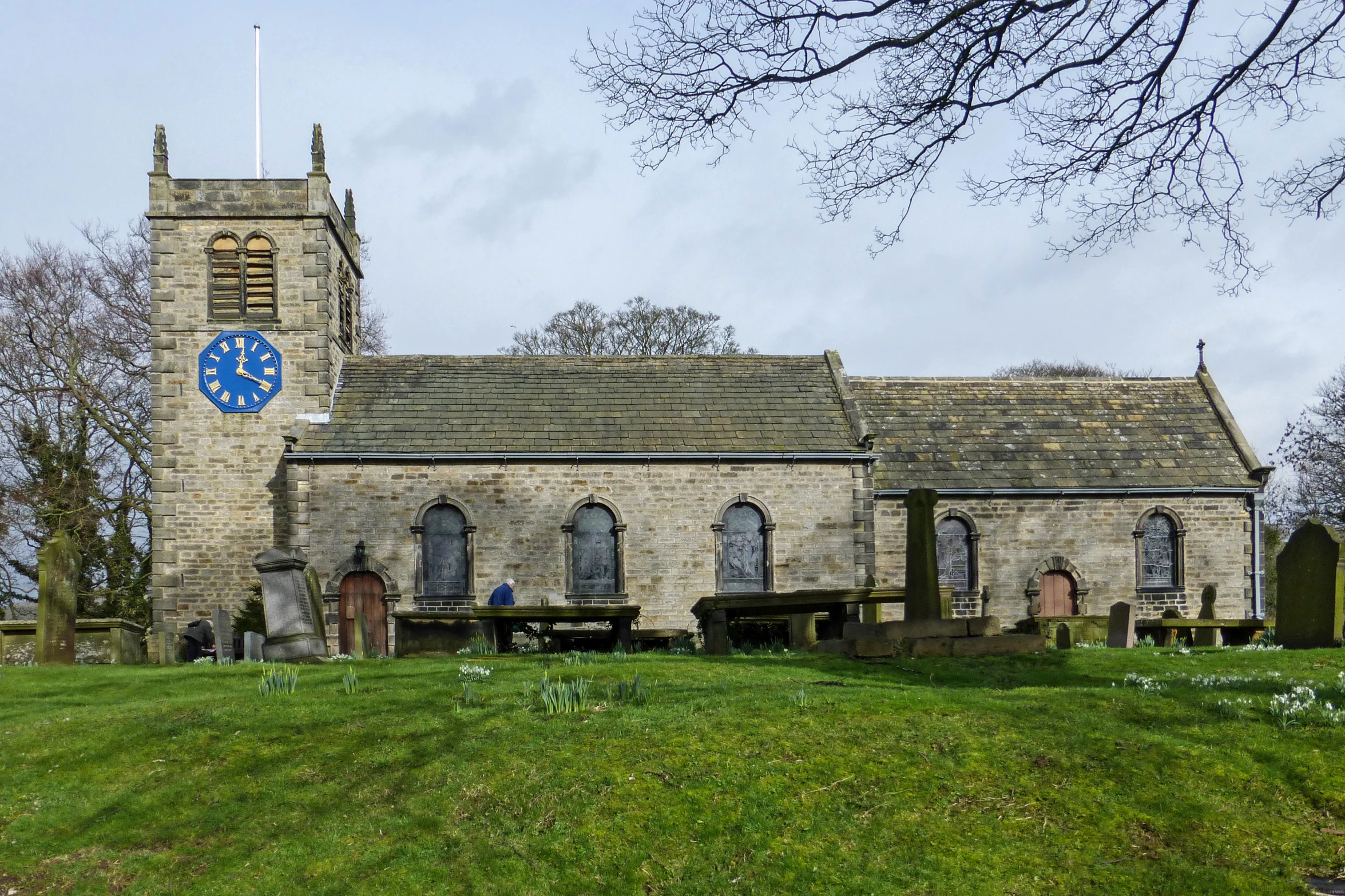 the building has two windows with a blue clock on it