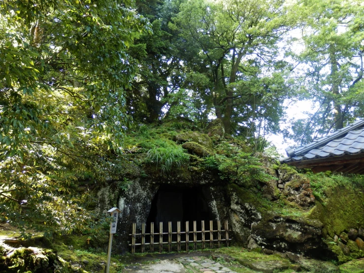 a building made out of rocks next to trees