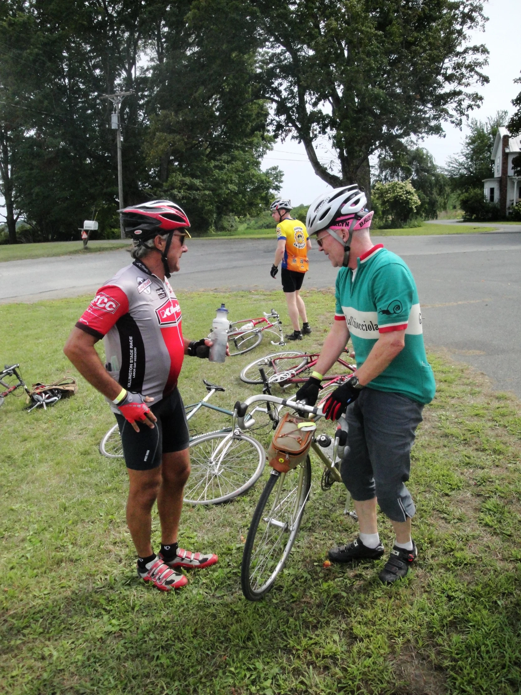 two people are talking near some bicycles