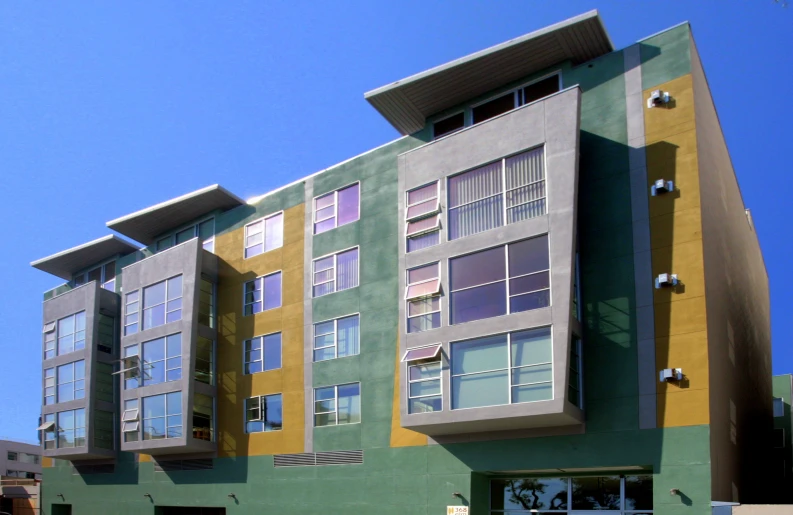 a building with multicolored exterior and street signs