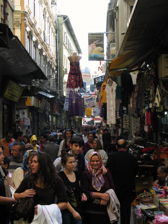 an image of many people walking around the market