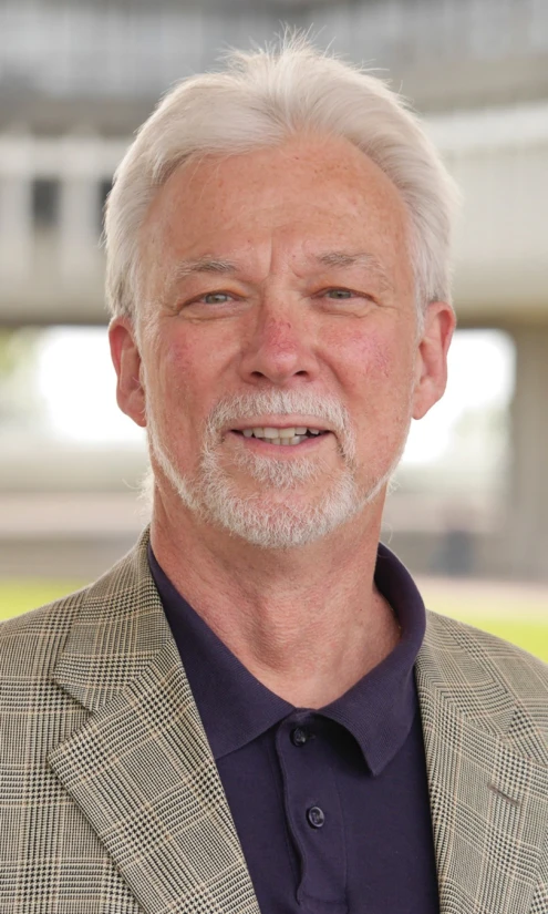 an older man with a white beard is smiling