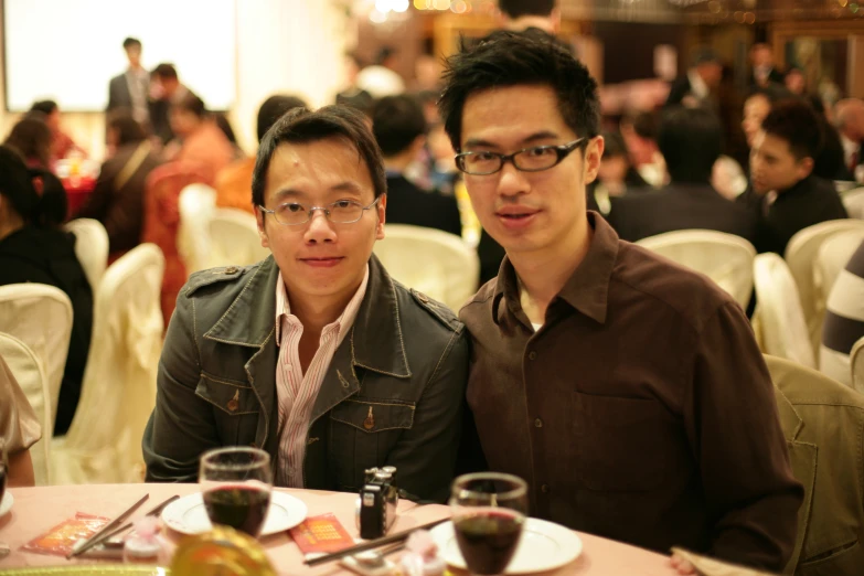 two men sitting together at a restaurant