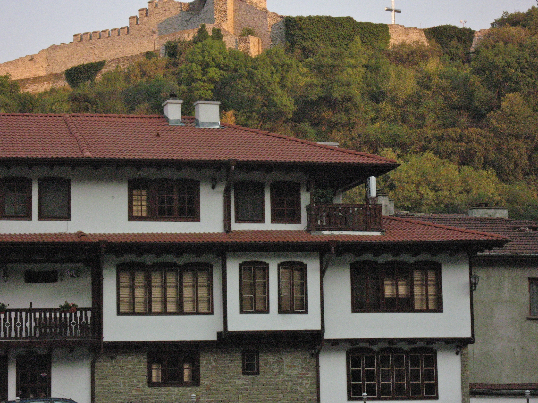 the white and brown building has brown windows