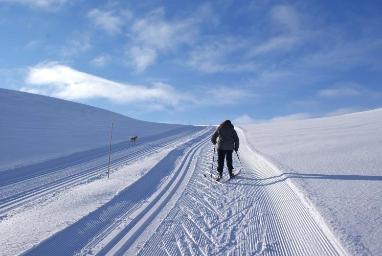 there is a woman walking through a snow covered slope