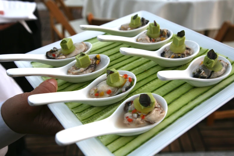 there are small bowls with food in them on a table