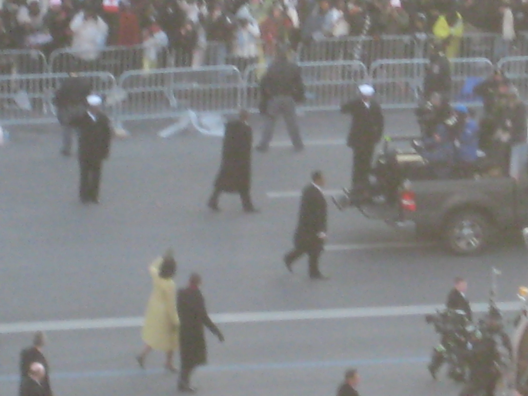 people are dressed in black and walking in the street