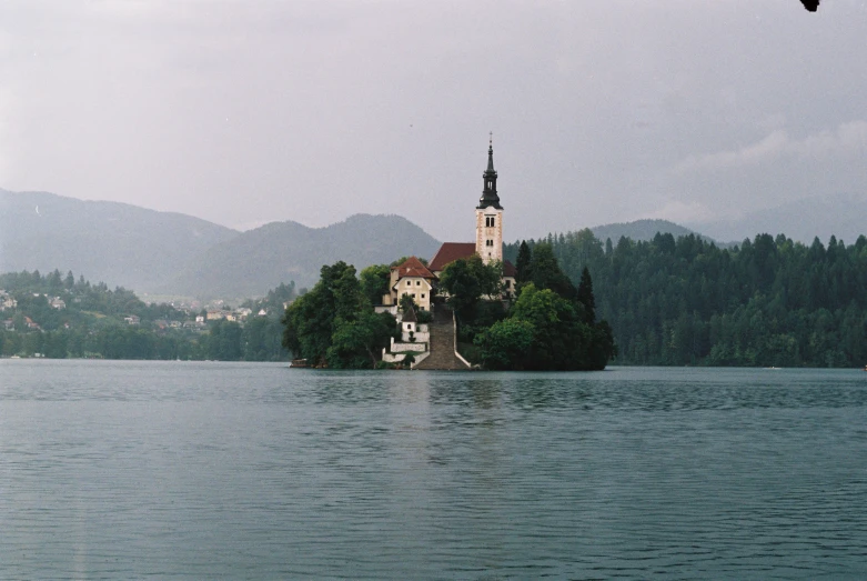 an island in the middle of a lake with a church on it