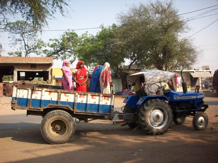 a truck carries several women and one car