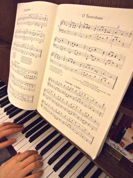 a person is reading a sheet of music by an organ